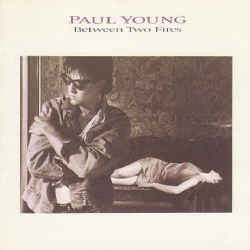 YOUNG, PAUL  - BETWEEN TWO FIRES